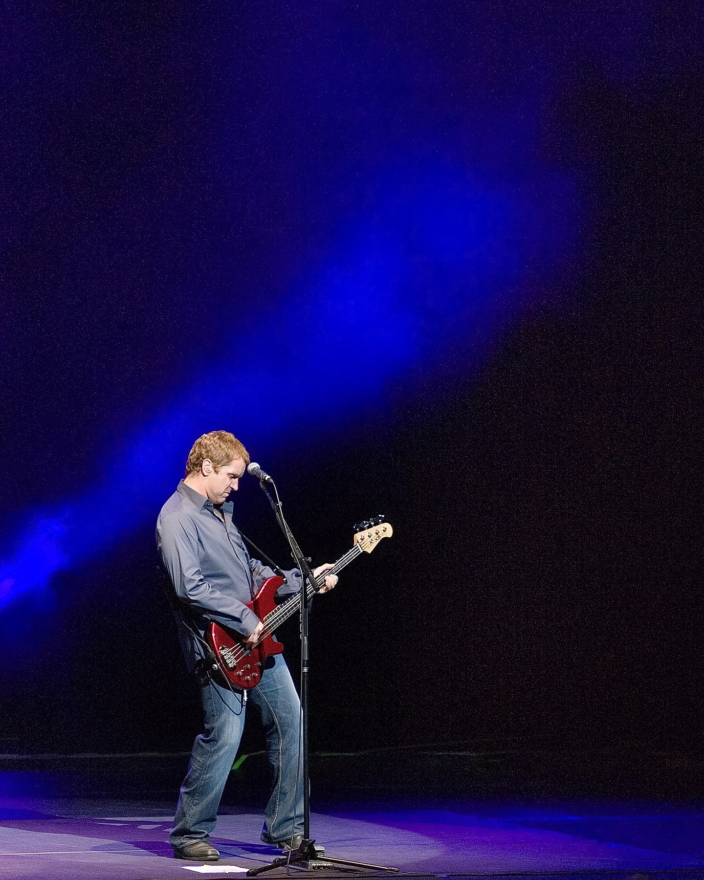 A performer on a dramatically-lit stage, photographed by DC Events Inc.